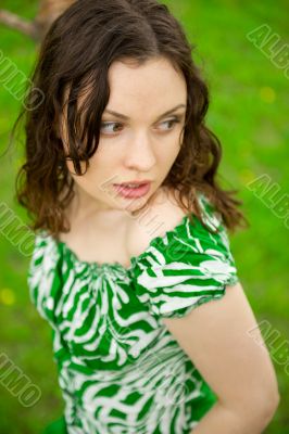 Closeup portrait of young beautiful woman wearing green dress si