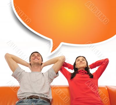 Young couple sitting on sofa and dreaming