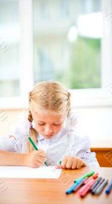 Little girl looking for a drawing concept wile painting picture 