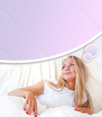 Young blond woman enjoying a sunny morning in bed