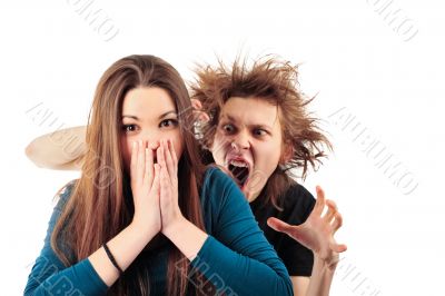 Mad man with funny hairdo tempting young girl for something