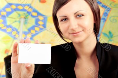 Closeup portrait of young pretty woman holding business card