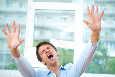 Portrait of young teacher screaming in empty classroom