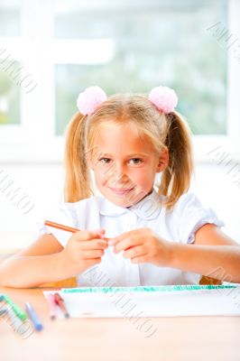 Little girl looking for a drawing concept wile painting picture 