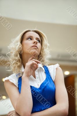 A portrait of a young business woman in a hall of an office buil