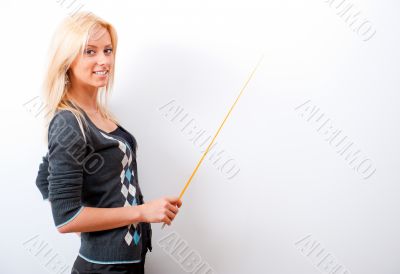 Portrait of young teacher pointing on white marker board in mode