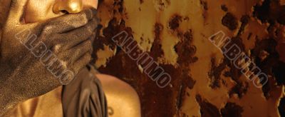 Portrait of young sexy woman in golden paint 