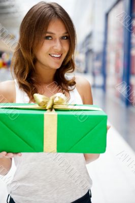 Portrait of young excited pretty woman standing inside shopping 