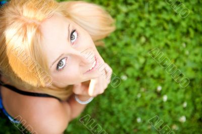 Smiling beautiful woman laying on grass. Smiling. Photo from abo