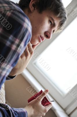 Happy young handsome man at home