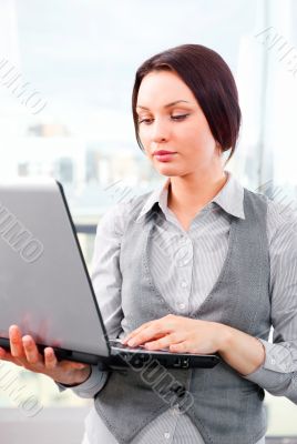 Beautiful business woman concentrating while working on computer