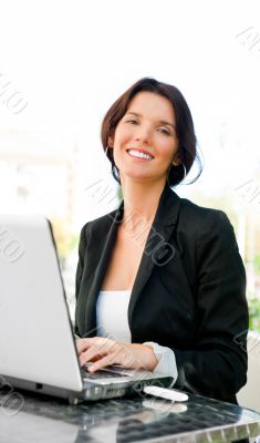 Young business woman on a laptop using wireless internet connect