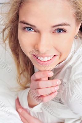 Portrait of young woman laying in bed