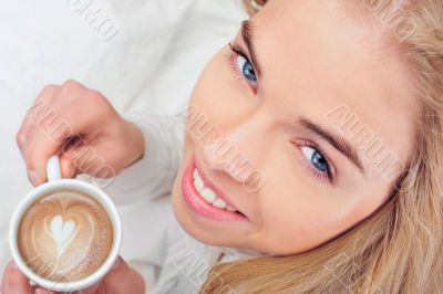 Portrait of young woman laying in bed