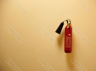 Fire extinguisher on the yellow wall