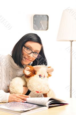 Closeup portrait of a young woman embracing her soft toy