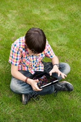 Young boy outdoors on the grass at backyard