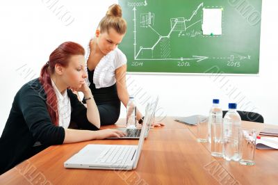 Portrait of two young business women at their office