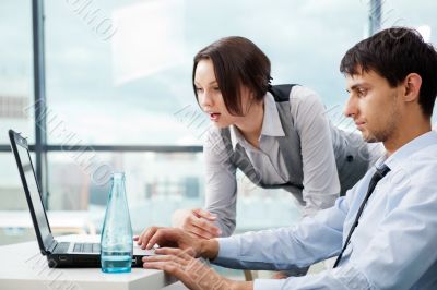 A business team of two colleagues planning work in office