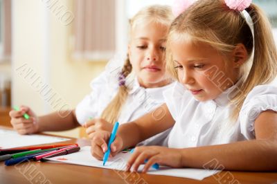 Little girls drawing pictures and writing letters to Santa Claus