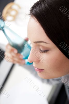 Young business woman drinking water, while having a brake at her