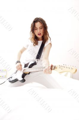 Portrait of beautiful young and attractive womanplaying her guit