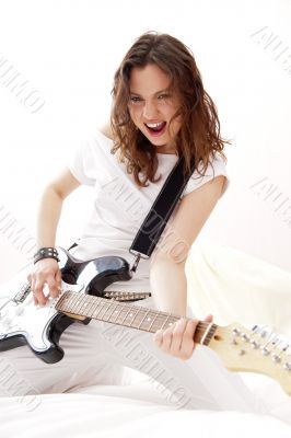 Portrait of young pretty girl who is feeling free and playing gu