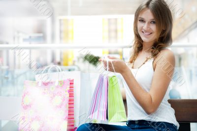 Happy shopping woman with bags and smiling. She is shopping insi Happy shopping woman with bags and smiling. She is shopping insi