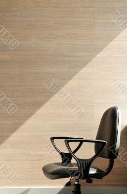 Portrait of an office chair facing the left.