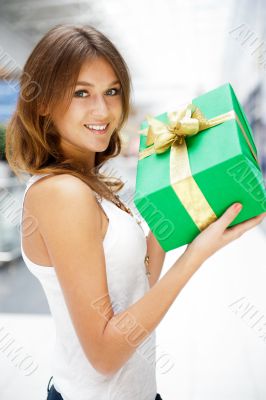 Portrait of young excited pretty woman standing inside shopping 
