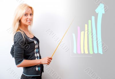 Young business teacher showing growing profit with graph on whit