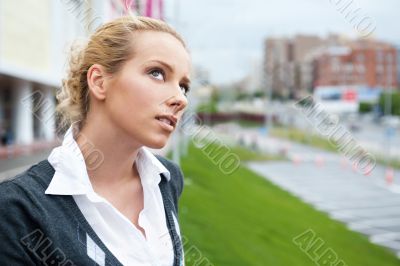 Closeup portrait of a beautiful woman in the city at summer time
