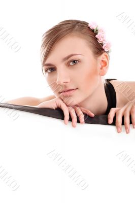 Portrait of a beautiful young woman behind a barrier with flower
