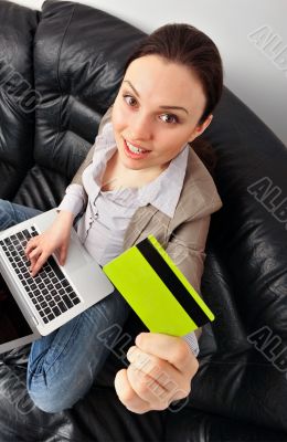 Portrait of beautiful business woman with laptop and credit card