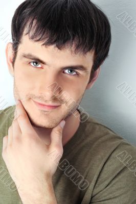 Handsome man casually leaning against the wall