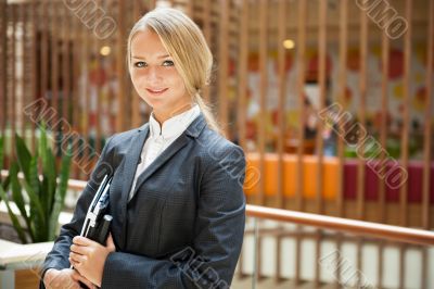 Portrait of a cute business woman with her laptop inside office 