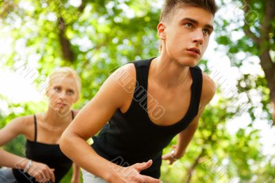 Closeup Portrait of Young Couple Jogging In Park