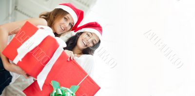 Young happy girls in Christmas hats.Standing together indoors an