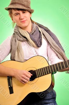 Closeup portrait of cute caucasian man playing the guitar over g