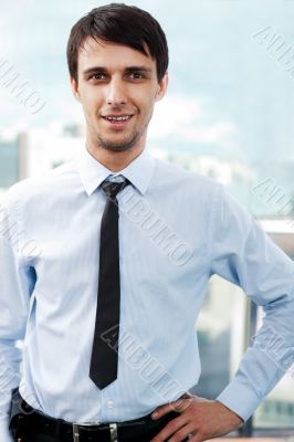 Portrait of young relaxed business man
