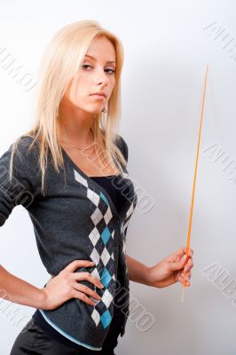 Portrait of young teacher pointing on white marker board in mode