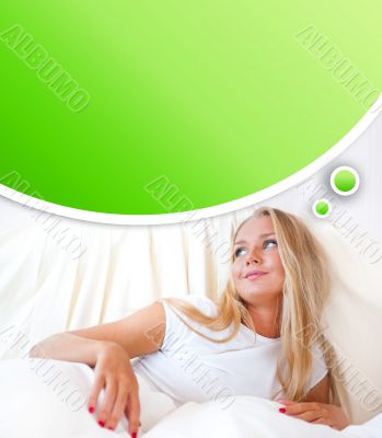 Young blond woman enjoying a sunny morning in bed