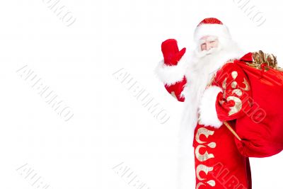 Santa Claus standing up on white background with his bag full of