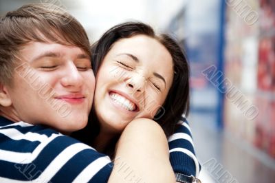 Young man meeting his girlfriend with opened arms at airport arr