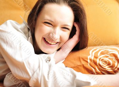 Closeup portrait of young pretty girl laying on her bed