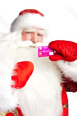 Traditional Santa Claus holding and sowing credit card while giv