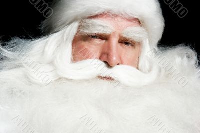 Santa Claus portrait smiling isolated over a black background