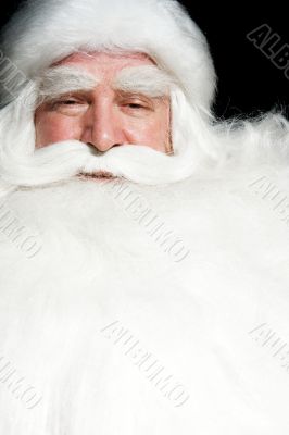 Santa Claus portrait smiling isolated over a black background
