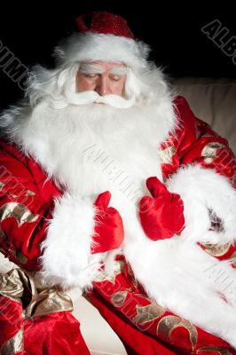 Santa sitting with a sack indoor at dark night room