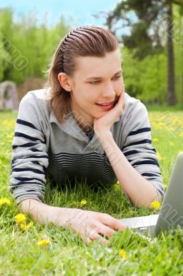 A smiling man with laptop outdoor